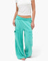 Beach Rose Co. teal mineral wash wide leg cargo pants with raw edge patch pockets and high-rise elastic waistband.