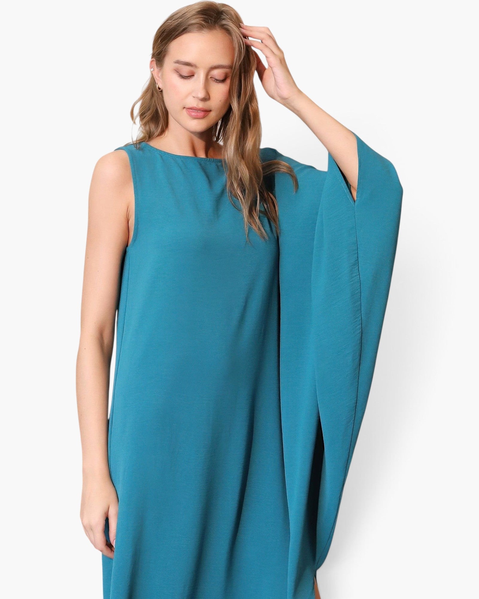 Beach Rose Co. teal matte crepe one-sleeve dress with a fluid, asymmetrical silhouette worn by a model.