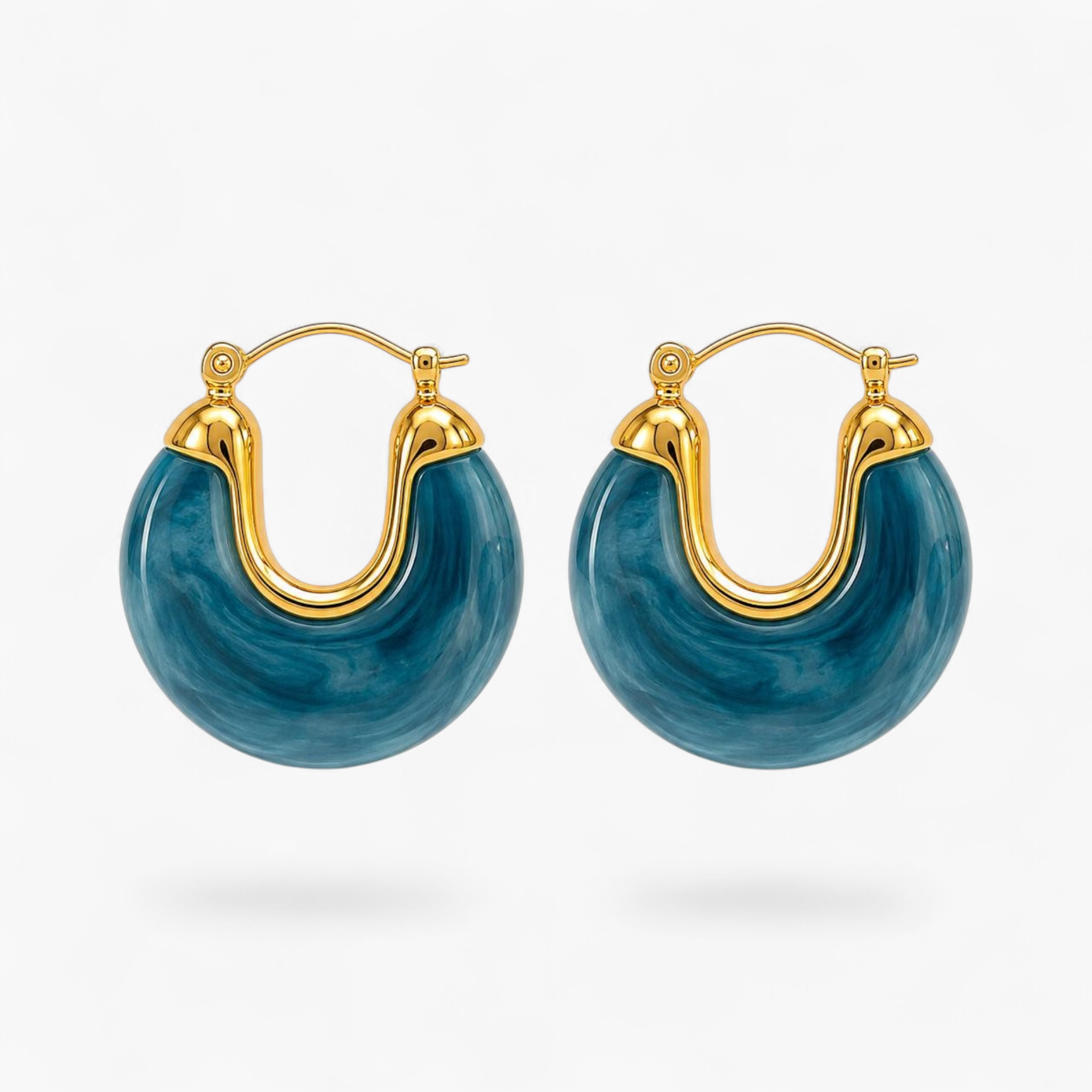 Beach Rose Co. marbled teal resin hoop earrings with 18K gold filled accents and a hinged closure.