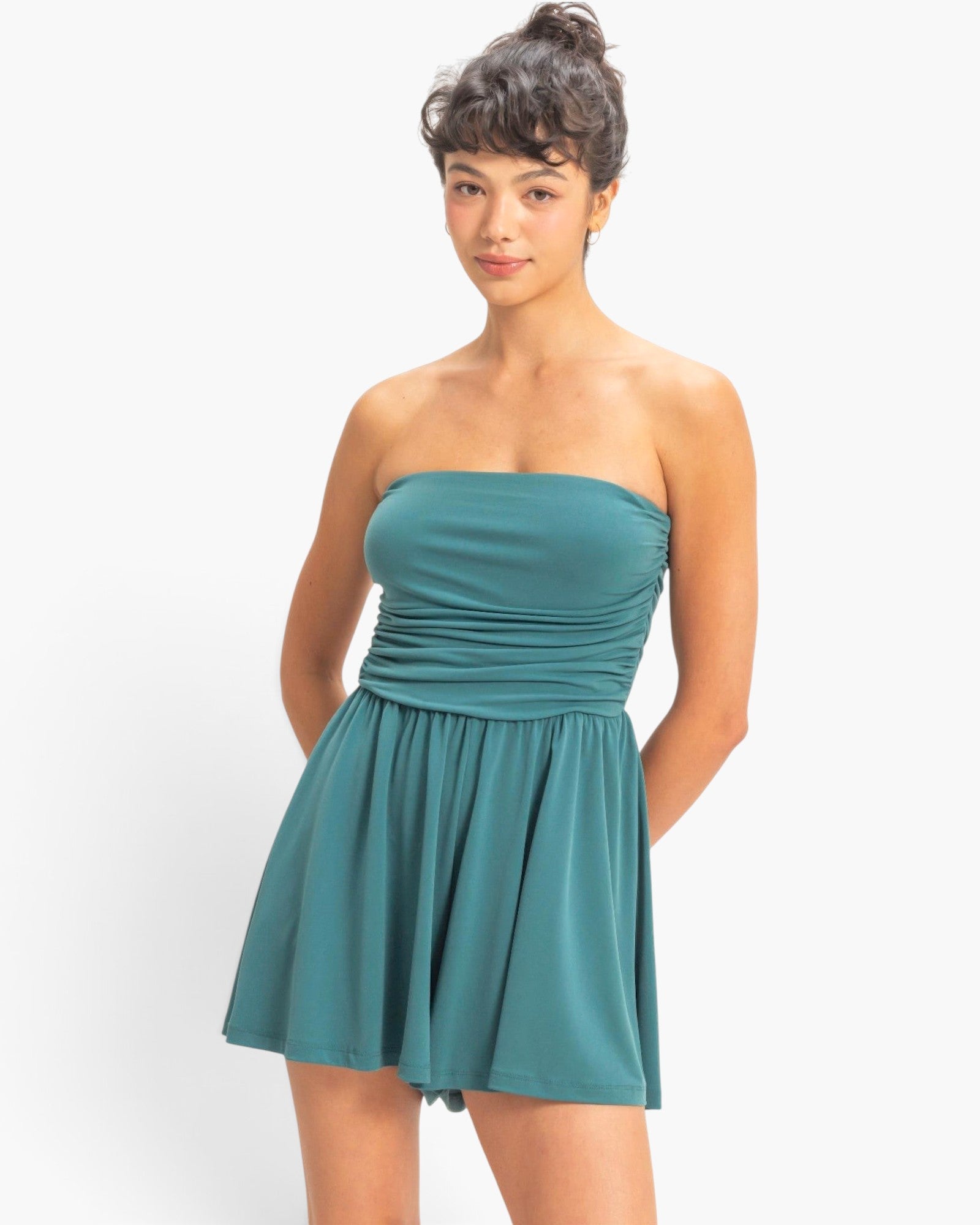 Beach Rose Co. teal strapless romper with shirred waist and flowy shorts worn by a model against a white background