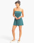 Model wearing a teal Beach Rose Co. strapless shirred waist romper with side pockets and relaxed shorts