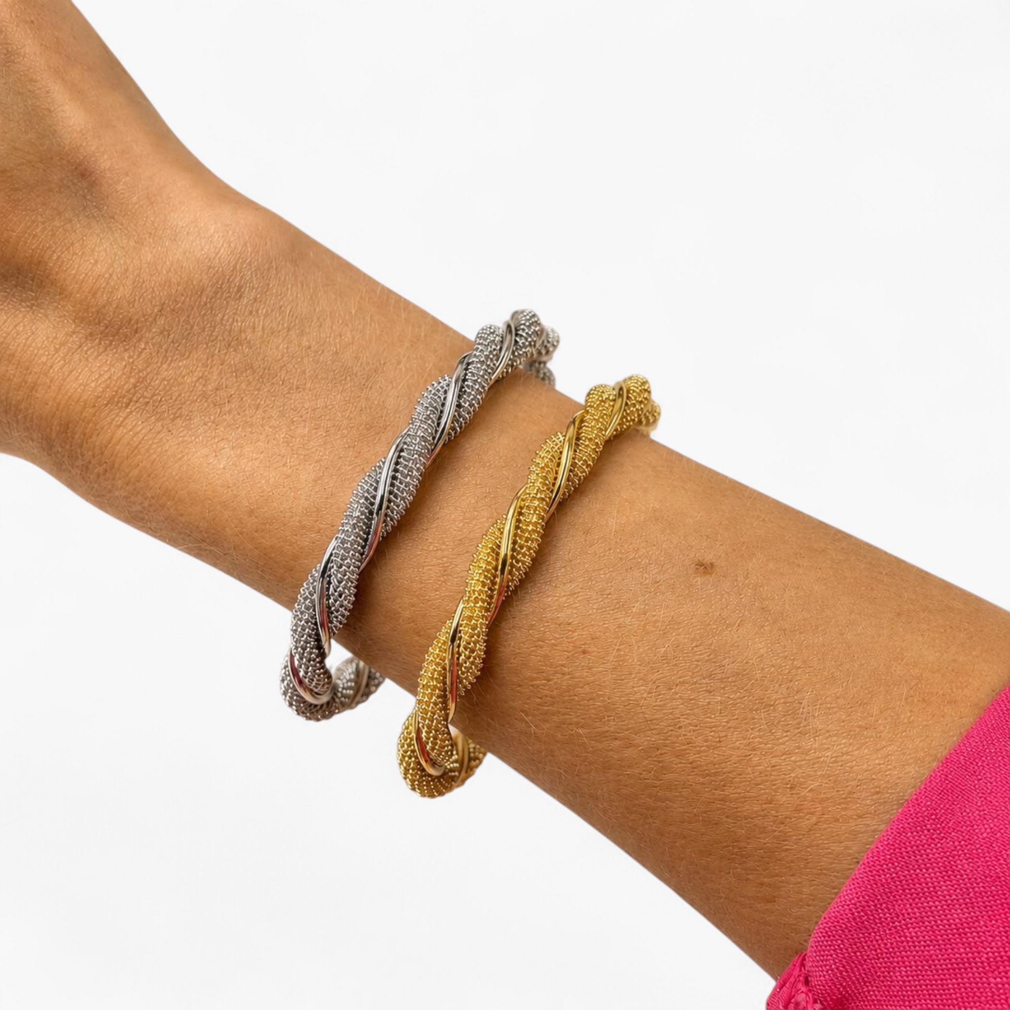 Beach Rose Co. textured twist open cuff bracelets in gold and rhodium worn on a wrist.
