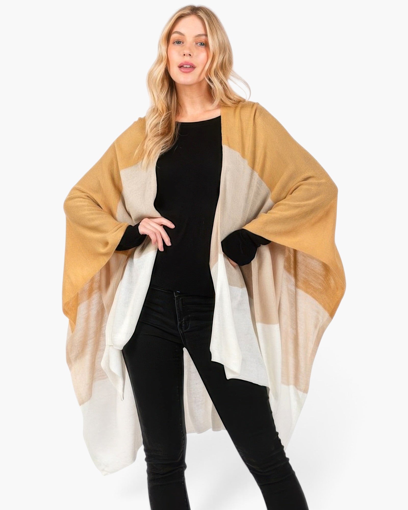 Beach Rose Co. Three Tones Ruana in neutral acrylic knit worn by a blonde model over a black outfit
