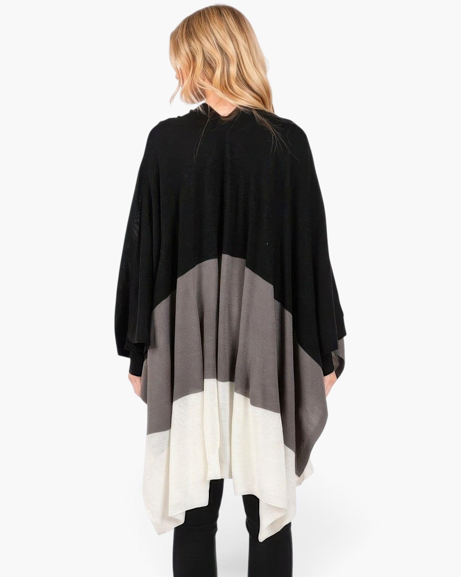 Beach Rose Co. Three Tones Ruana in black, grey, and white acrylic knit worn by a blonde woman from the back view.