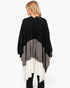 Beach Rose Co. Three Tones Ruana in black, grey, and white acrylic knit worn by a blonde woman from the back view.