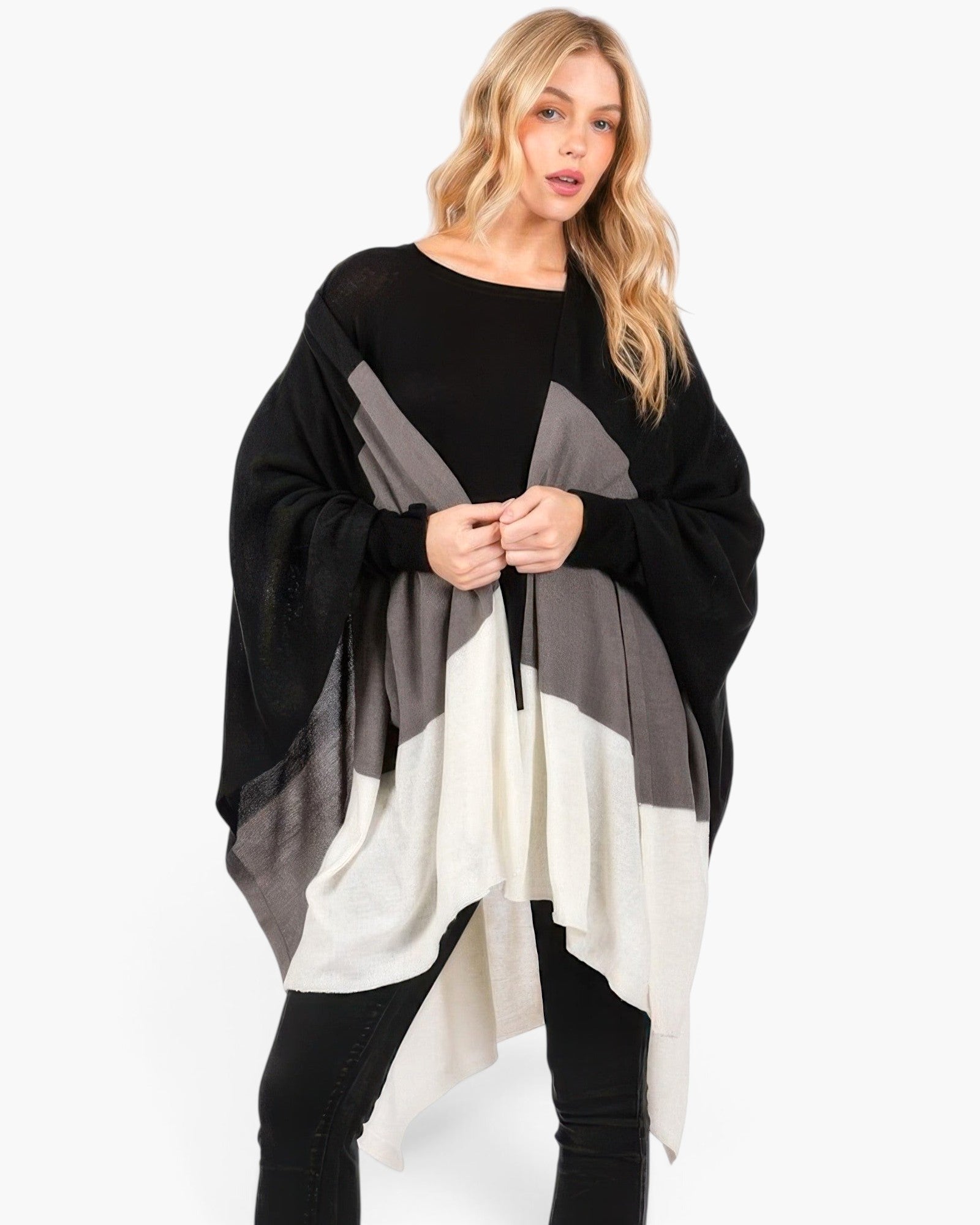 Beach Rose Co. Three Tones Ruana in black, grey, and white acrylic knit worn by a blonde model over a black outfit.