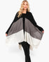 Beach Rose Co. Three Tones Ruana in black, grey, and white acrylic knit worn by a blonde model on white background.