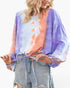 Beach Rose Co. tie-dye balloon sleeve top with round neck and drawstring waist worn by a blonde model with denim shorts