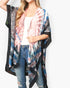 Beach Rose Co. tie-dye boho kimono with black mandala border, worn over a white tank top and distressed denim jeans.