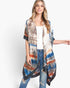 Beach Rose Co. tie dye boho kimono with vibrant blue and orange patterns, worn over a white top and distressed jeans.