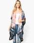 Beach Rose Co. model wearing a lightweight, open-front tie-dye boho kimono with pink, blue, and black patterns.
