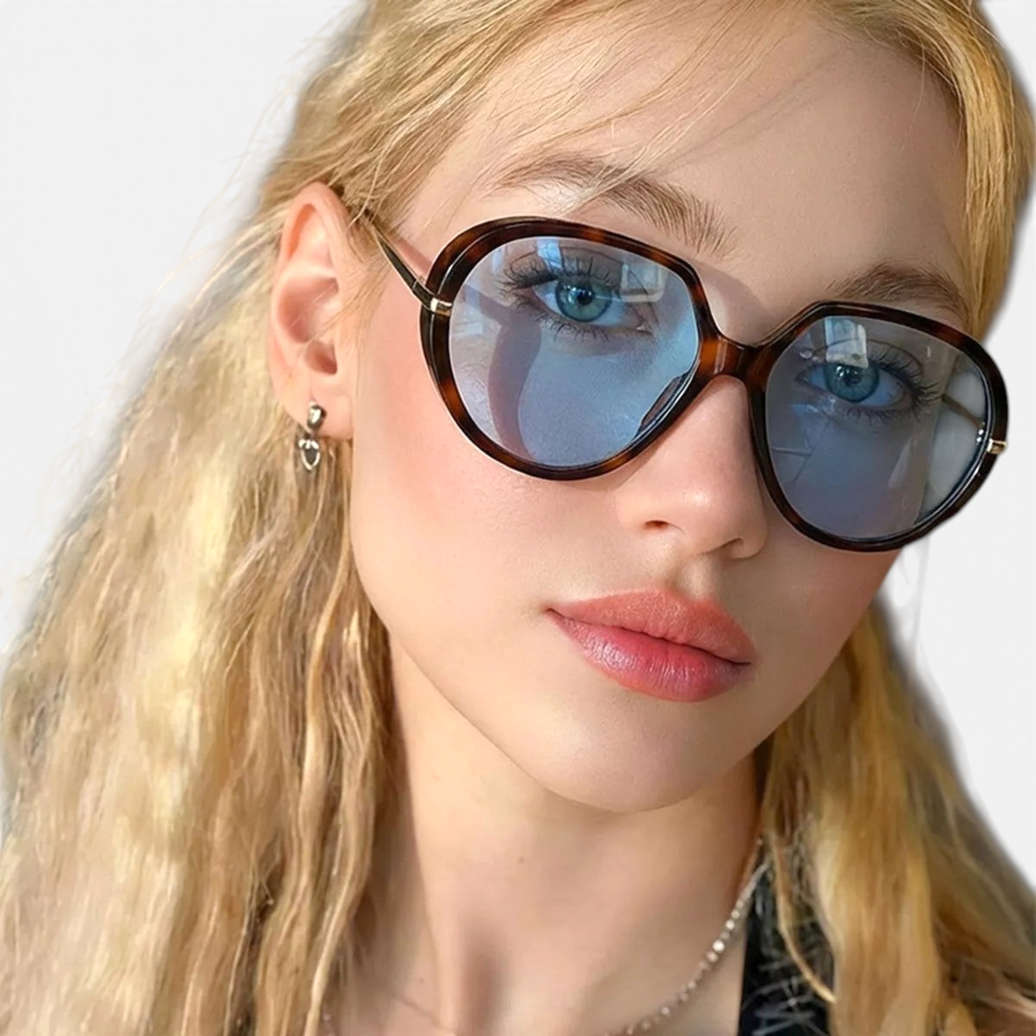 Beach Rose Co. oversized butterfly sunglasses with tortoiseshell frames and blue tinted lenses on a blonde model