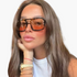 Beach Rose Co. vintage square sunglasses with tortoise shell frames and orange lenses on a woman