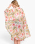 Beach Rose Co. tropical floral print shawl cover-up with a lightweight, airy drape worn by a blonde woman.