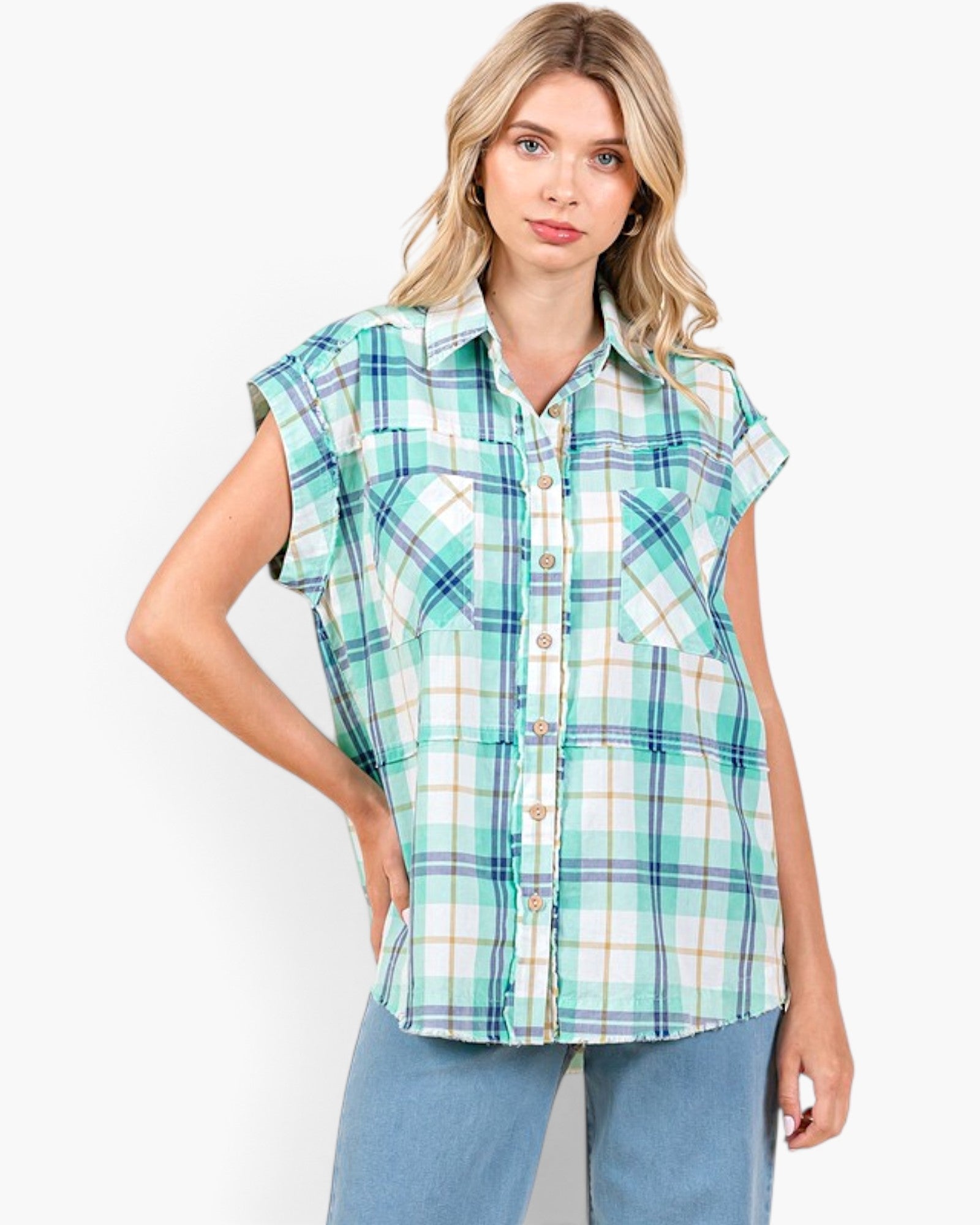 Beach Rose Co. turquoise plaid cotton button-front shirt with cap sleeves, chest pockets, and raw hem on a model