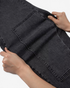 Beach Rose Co. washed black barrel leg jeans showing the stretch of the cotton blend fabric and panel seam detail