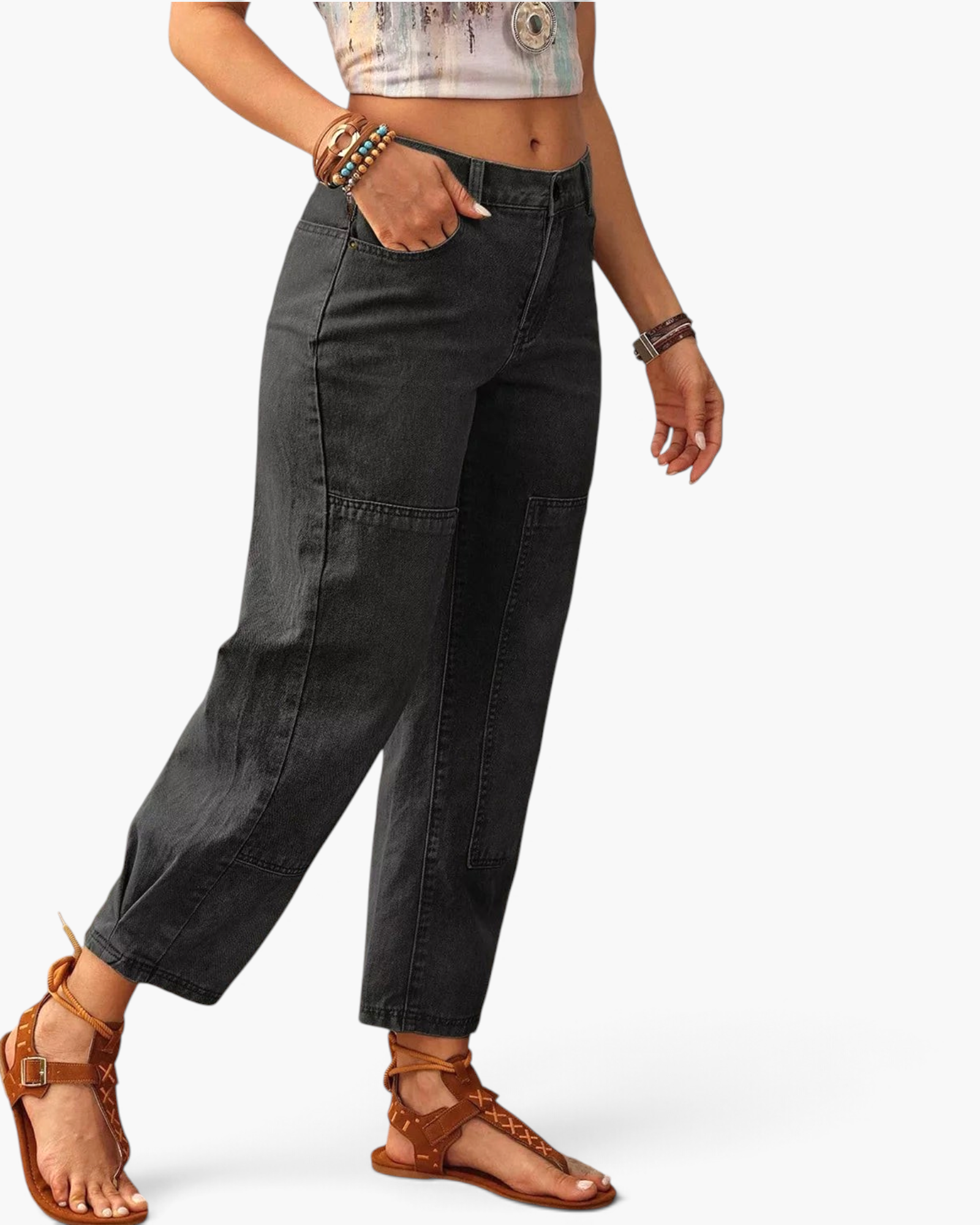Beach Rose Co. washed black barrel leg jeans with panel detailing and cropped hem worn with brown strappy sandals.