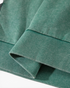 Beach Rose Co. washed green cotton hoodie featuring a textured ribbed hem and a soft, mottled fabric finish.