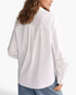 Beach Rose Co. white long-sleeve blouse with back yoke pleat and openwork sleeve detail worn with blue jeans