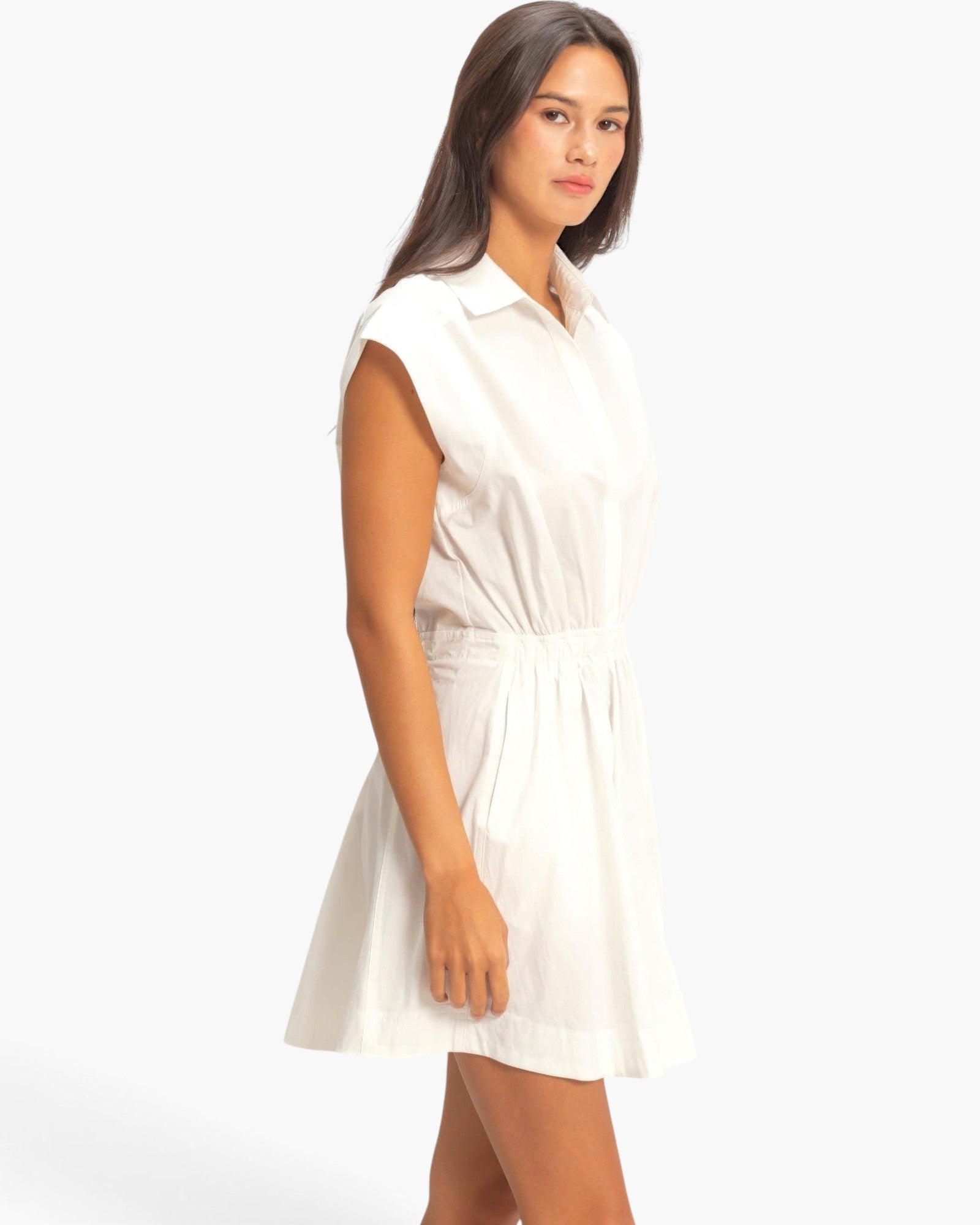 Beach Rose Co. white sleeveless cotton mini dress with a collared neckline and shirred elastic waist on a model