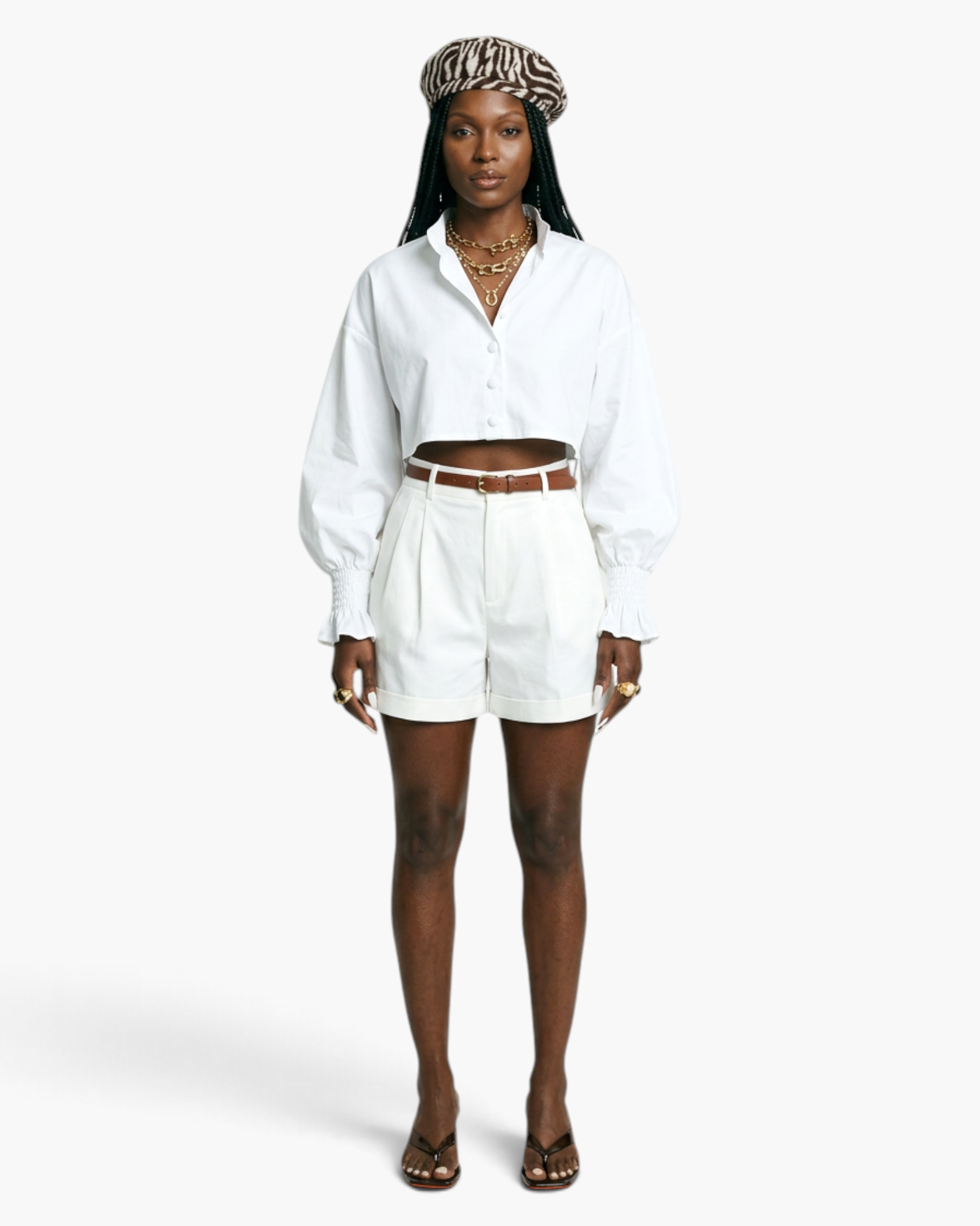 Beach Rose Co. white cropped blouse with balloon sleeves, smocked cuffs, and button front worn with white shorts.