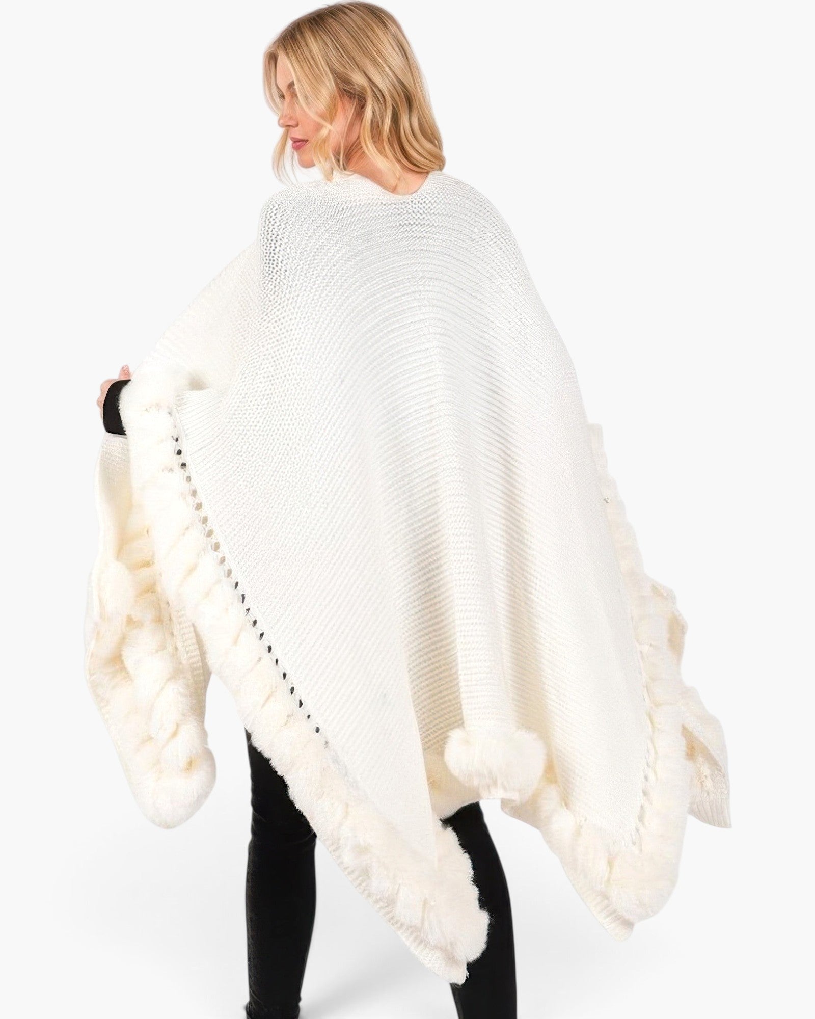 Beach Rose Co. white knit cape with plush faux fur trim and front clasp closure worn by a blonde woman
