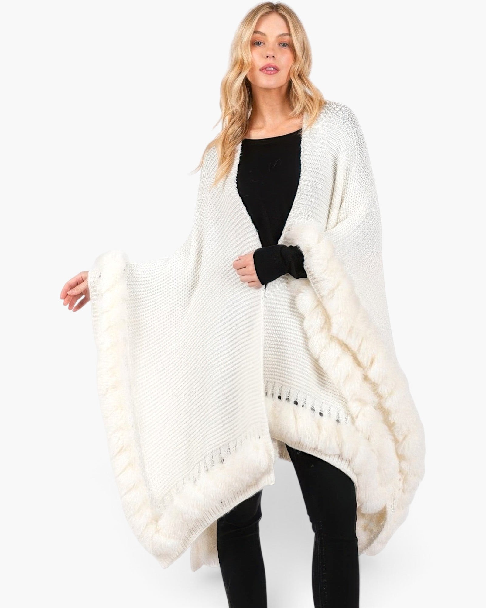 Beach Rose Co. white knit cape with plush faux fur trim and front closure worn by a blonde model