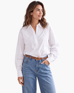 Beach Rose Co. white long-sleeve blouse with floral embroidery, pointed collar, and openwork sleeve details.
