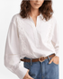 Beach Rose Co. white blouse with floral embroidery, pointed collar, split neckline, and openwork sleeve details.
