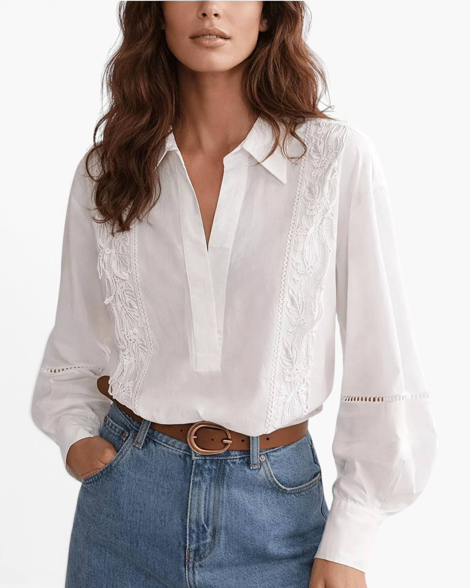 Beach Rose Co. white blouse with floral embroidery, pointed collar, and openwork sleeve details worn with blue jeans.
