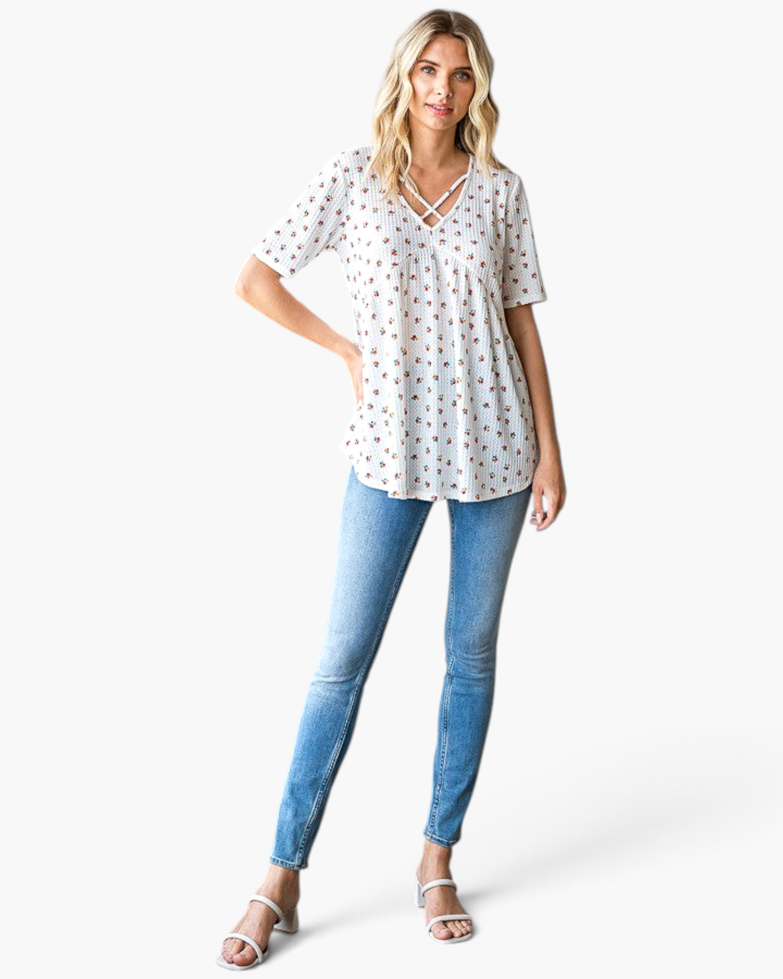 Beach Rose Co. white textured waffle knit tunic with a ditsy floral print and crisscross V-neckline on a model