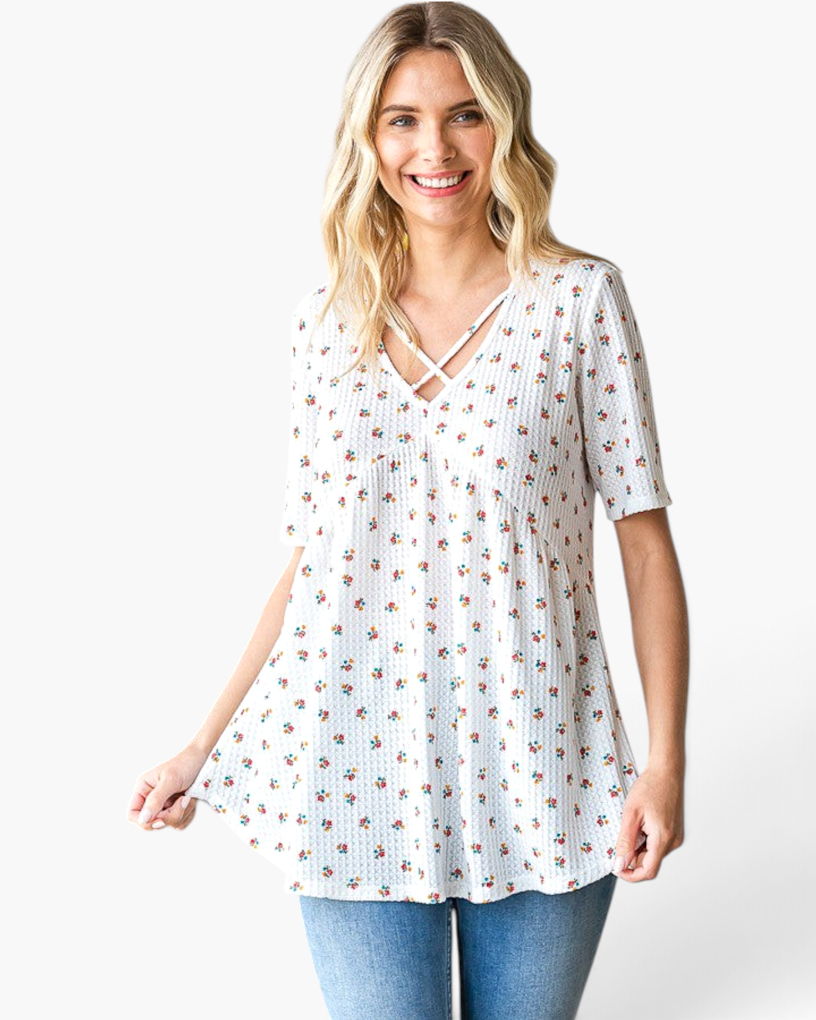 Beach Rose Co. white waffle knit tunic with a colorful ditsy floral print and crisscross V-neckline on a model.