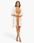 Beach Rose Co. white flutter sleeve kimono cover-up worn over a striped bikini on a model.