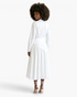 Beach Rose Co. white long-sleeve blouse and midi skirt set with pearl embellishments and asymmetrical draped waist.