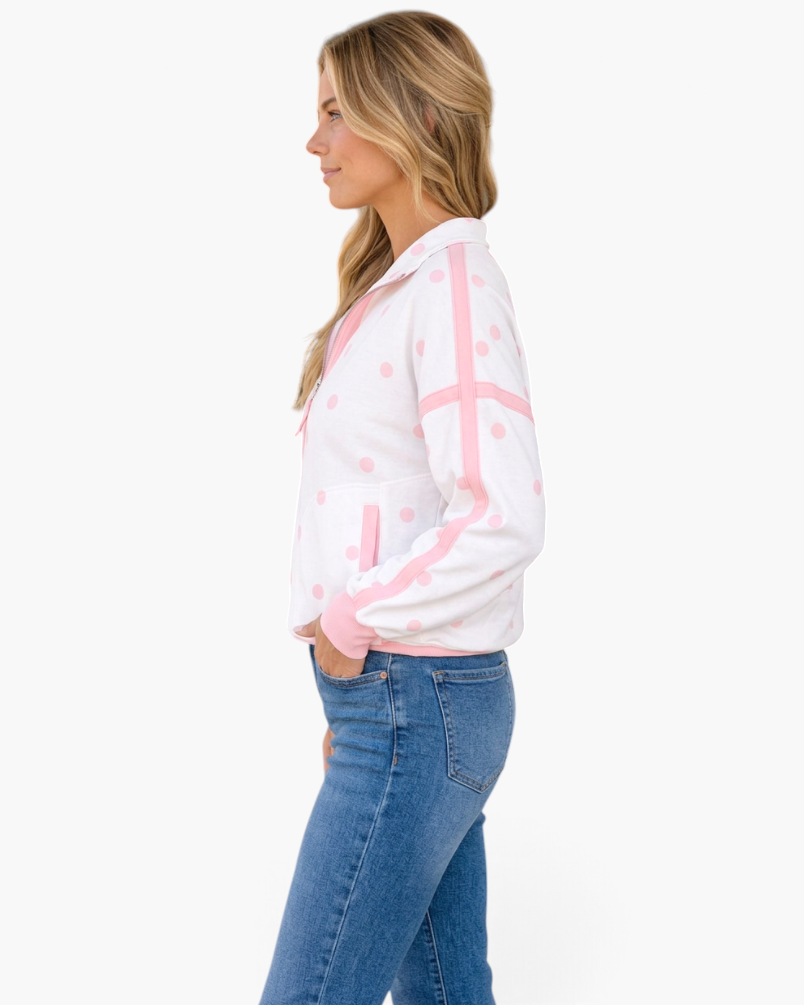 Beach Rose Co. white half-zip sweatshirt with pink polka dots, contrast trim, and long sleeves worn with blue jeans.