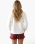 Beach Rose Co. white long sleeve lounge top and red plaid ruffle shorts worn by a woman from the back view.