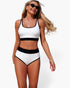 Beach Rose Co. white high-waisted bikini set with black contrast trim and textured polka-dot pattern on a model