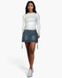 Beach Rose Co. white long-sleeve ribbed crew-neck top worn by a model with a denim mini skirt and white sneakers.
