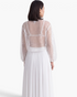 Beach Rose Co. white sheer mesh top with scattered sequins and long balloon sleeves, back view.
