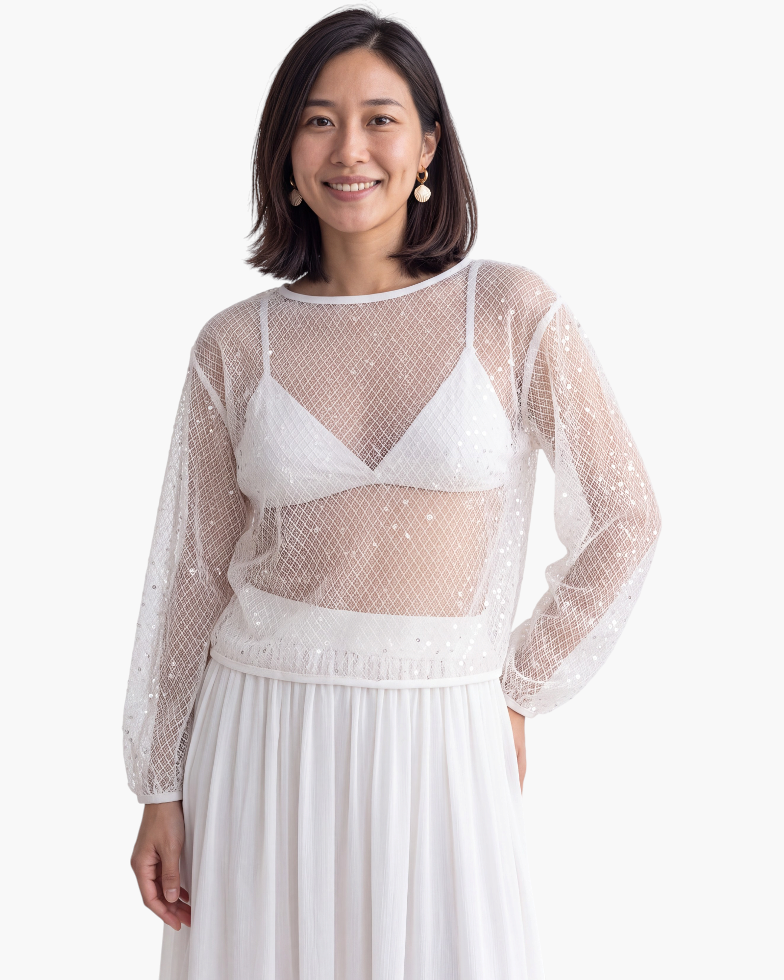 Beach Rose Co. white sheer mesh top with scattered sequins and long balloon sleeves worn over a white bralette.