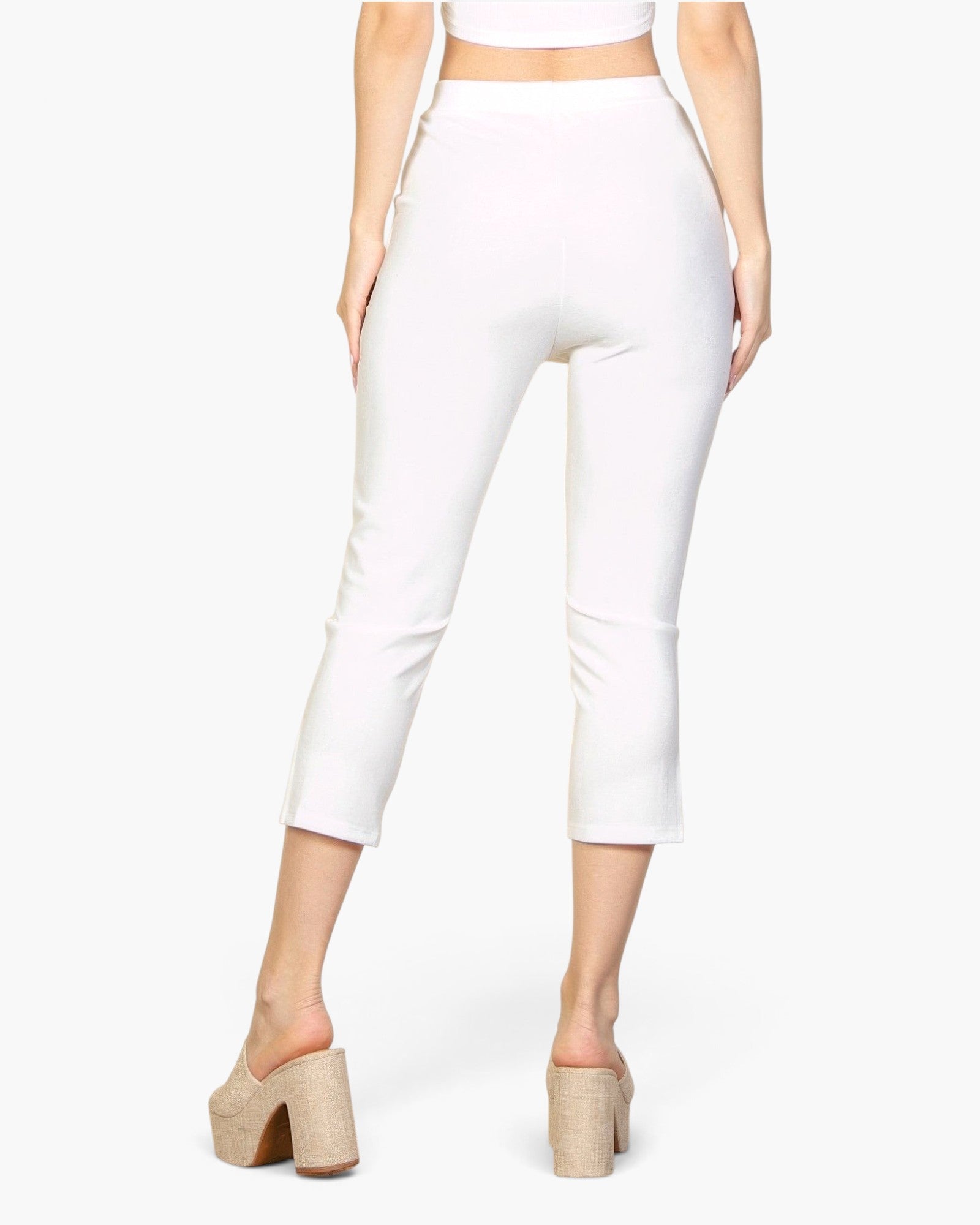 Beach Rose Co. white cropped pants with a slit hem and elastic waist, worn by a model in beige platform mules.