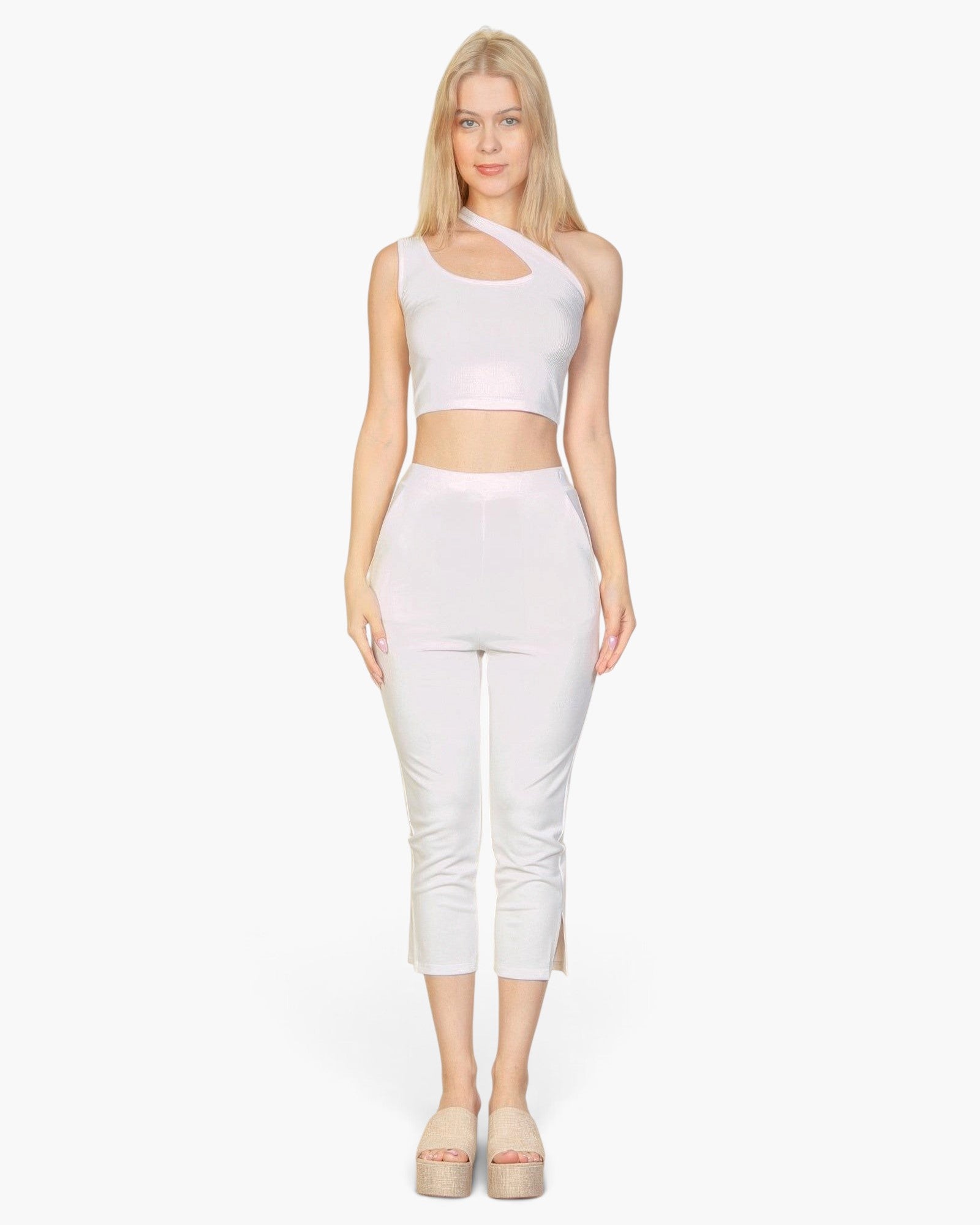Beach Rose Co. white slit hem cropped pants in stretch crepe fabric worn by a model with a matching crop top