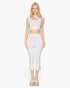 Beach Rose Co. white slit hem cropped pants in stretch crepe fabric worn by a model with a matching crop top