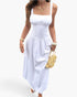 Beach Rose Co. white sleeveless A-line maxi dress with a square neckline, worn by a woman with a straw handbag.
