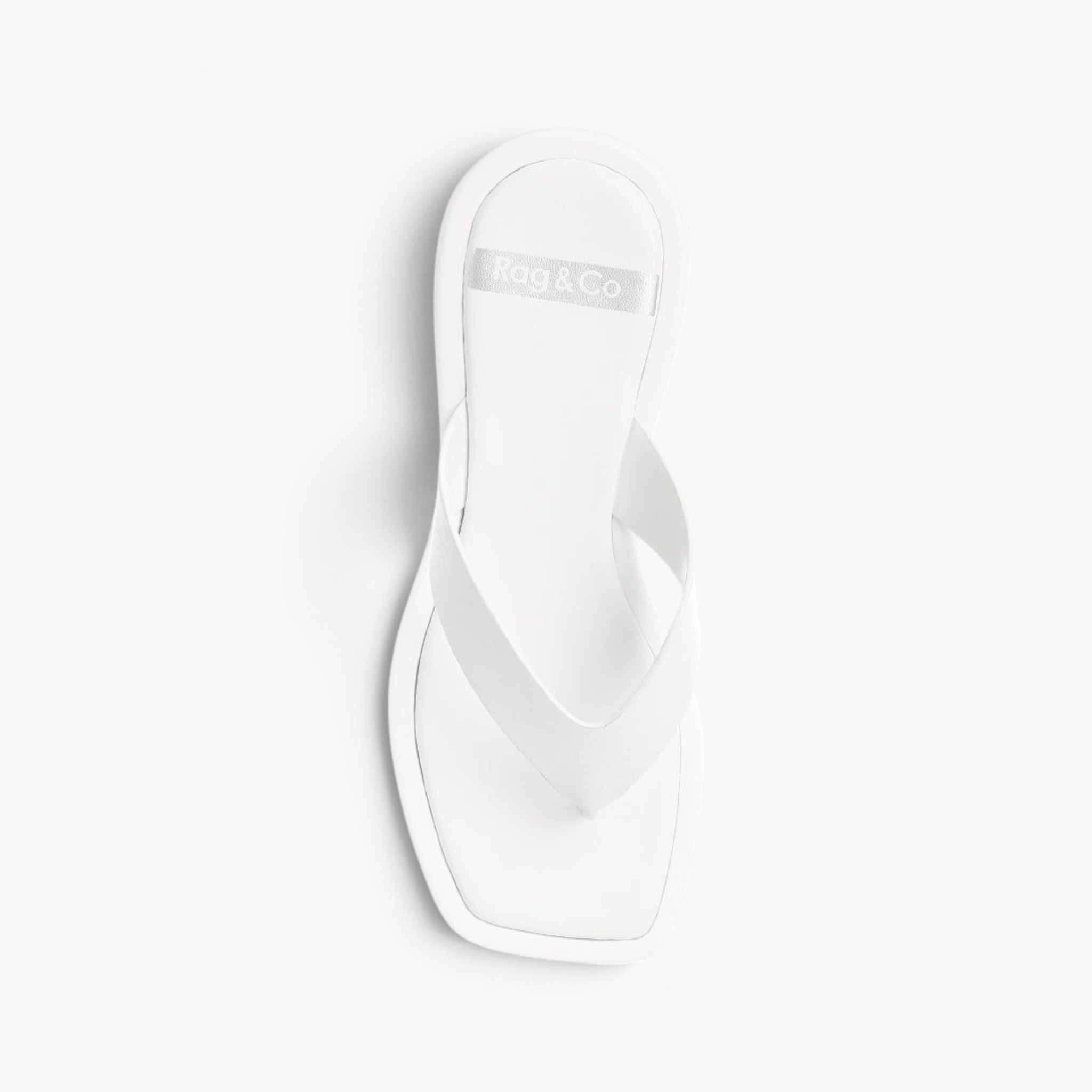 Beach Rose Co. white faux leather thong sandals featuring an open square toe and cushioned flat footbed.