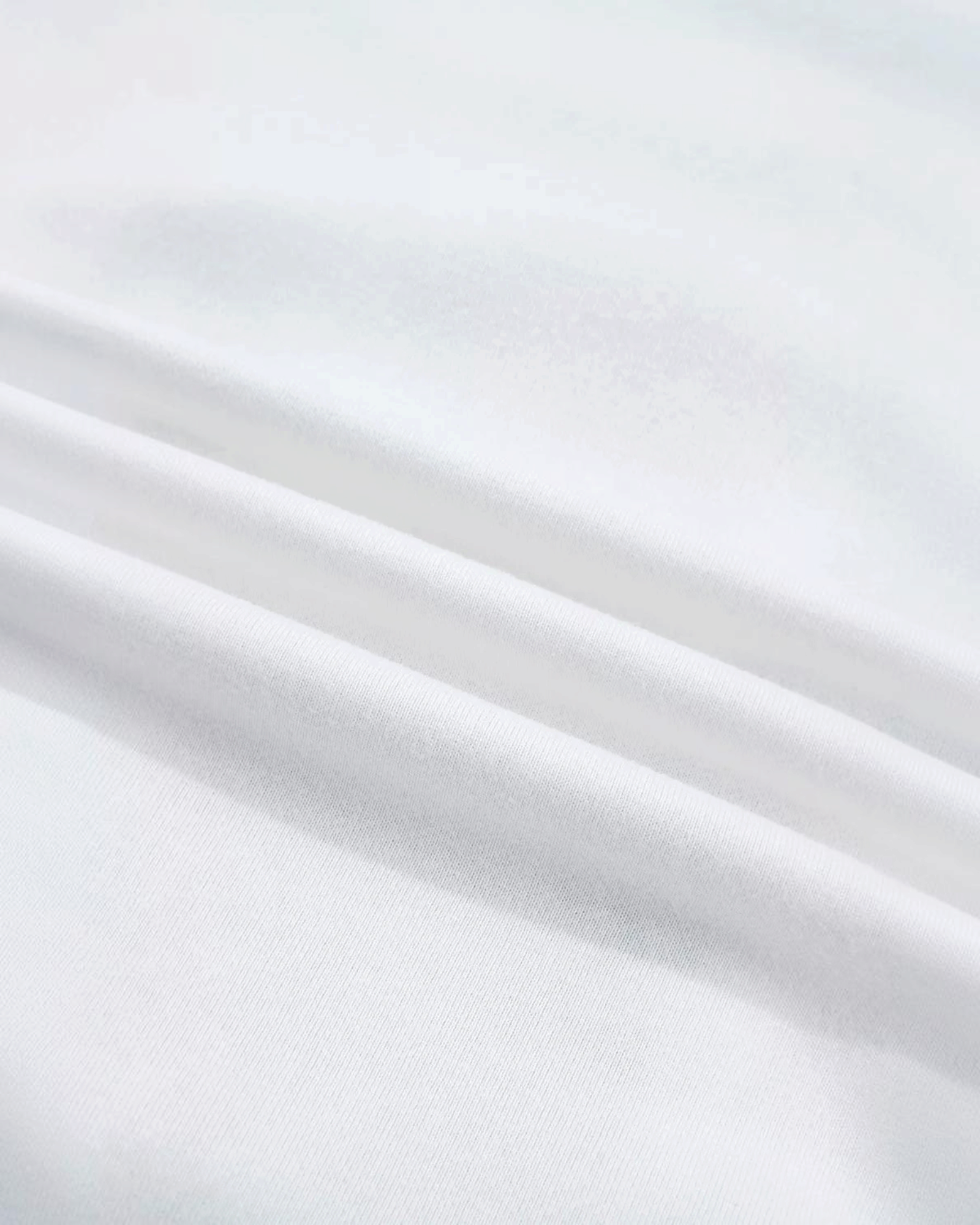 Close-up of soft white cotton-polyester blend fabric from a Beach Rose Co. Christmas sweatshirt.