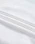 Close-up of soft white cotton-polyester blend fabric from a Beach Rose Co. Christmas sweatshirt.