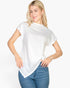 Beach Rose Co. white batwing sleeve tee with a twist front detail worn by a blonde model with blue jeans