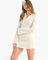 Beach Rose Co. white waffle knit mini dress with a collared neckline and long bell sleeves worn by a model