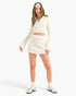 Beach Rose Co. white waffle knit two-piece set with a collared bell sleeve crop top and matching mini skirt on a model